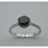 A 9 ct white gold and black diamond solitaire ring, the stone approximately 1.25 carats.