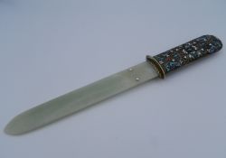 An enamel and silver mounted jade page turner, bearing Russian marks. 29 cm long.