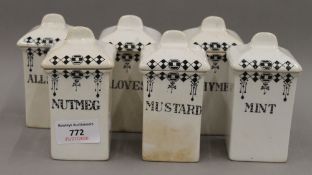 A set of white porcelain spice jars. 11 cm high.