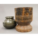 An Antique lignum vitae mortar and an early European bulbous bronze cooking pot.