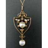 An Edwardian 9 ct gold and pearl Art Nouveau pendant on a modern 9 ct gold chain.