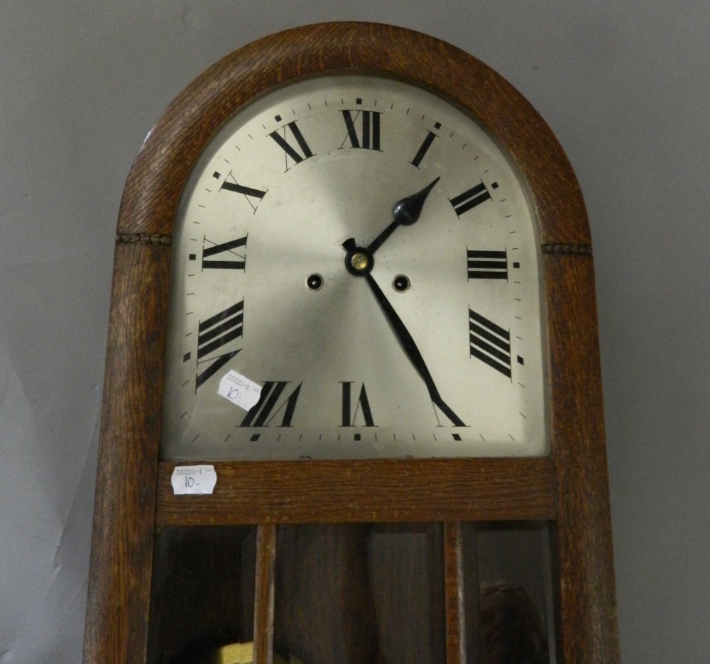 An early 20th century oak wall clock. 72 cm high. - Image 2 of 3
