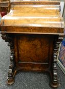 A Victorian walnut davenport. 57 cm wide.