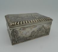 An embossed Dutch silver box. 18.5 cm wide (32.2 troy ounces total weight).