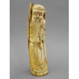 A 19th century Chinese carved ivory figure of Shao Loa, typically modelled holding a staff.