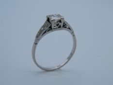 An Art Deco white metal (possibly platinum) 1/4 carat diamond solitaire ring,