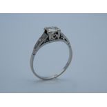 An Art Deco white metal (possibly platinum) 1/4 carat diamond solitaire ring,