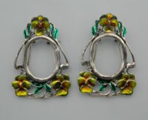 A pair of small silver and enamel Art Nouveau style frames. 4.5 cm high.