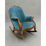 A Victorian rosewood rocking chair. 65 cm wide.