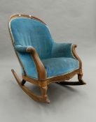 A Victorian rosewood rocking chair. 65 cm wide.