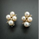 A pair of 14 K white gold pearl and diamond earrings. 1.