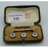 A boxed set of buttons and a stock pin