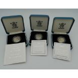 Three £1 silver proof coins,