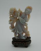 A Chinese carved stone figure of Guanyin, on stand. 6.5 cm high excluding stand.