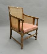 An early 20th century bergere armchair. 52 cm wide.