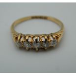 An 18 ct gold five stone diamond ring.