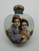 An early 20th century silver mounted heart shaped porcelain scent bottle. 5.5 cm high.