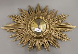 A sunburst clock. 58 cm wide.