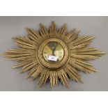 A sunburst clock. 58 cm wide.