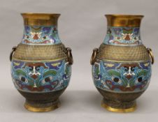 A pair of late 19th/early 20th century cloisonne decorated bronze vases. 29.5 cm high.