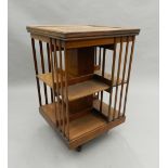 A Victorian walnut revolving bookcase. 82 cm high, 53 cm wide, 53 cm deep.