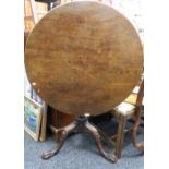 A Georgian mahogany tilt top tripod table. 85 cm diameter.