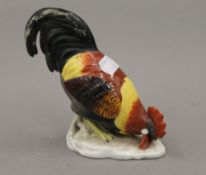 A 19th century porcelain model of a cockerel. 14 cm high.