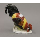 A 19th century porcelain model of a cockerel. 14 cm high.