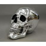 A silver coloured model skull.
