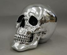 A silver coloured model skull.