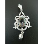 A silver and cubic zirconia pendant. 6 cm high.