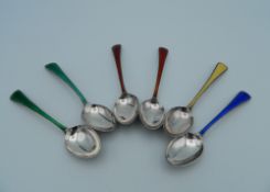 A set of six silver and enamel Cartier coffee spoons. 10 cm long (79.