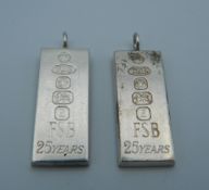 Two silver ingot form pendants. 3.5 cm high.