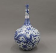 A large Chinese blue and white porcelain vase decorated with dragons. 39 cm high.