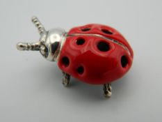 A silver model of a ladybird. 2.5 cm long.