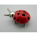 A silver model of a ladybird. 2.5 cm long.