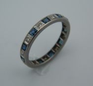 An Art Deco full eternity ring, set with diamonds and calibre cut sapphires,