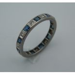 An Art Deco full eternity ring, set with diamonds and calibre cut sapphires,