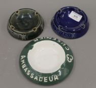 Two Royal Doulton advertising ash trays for H E Olby & Co and another.