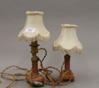 A pair of 19th century rouge marble candlesticks (adapted to electricity).