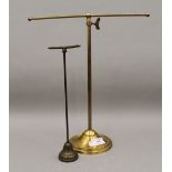 Two vintage brass shop display stands. The largest 36 cm high.