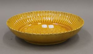 A Chinese yellow ground porcelain plate. 22.5 cm diameter.