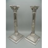 A pair of hallmarked English silver Corinthian column candlesticks. One sconce lacking. 31 cm high.