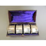 A cased of four silver napkin rings. Each 4.5 cm diameter (3.4 troy ounces).