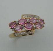 A 9 ct gold diamond and pink sapphire ring.