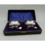 A cased pair of silver salts. Case 19 cm wide (1.