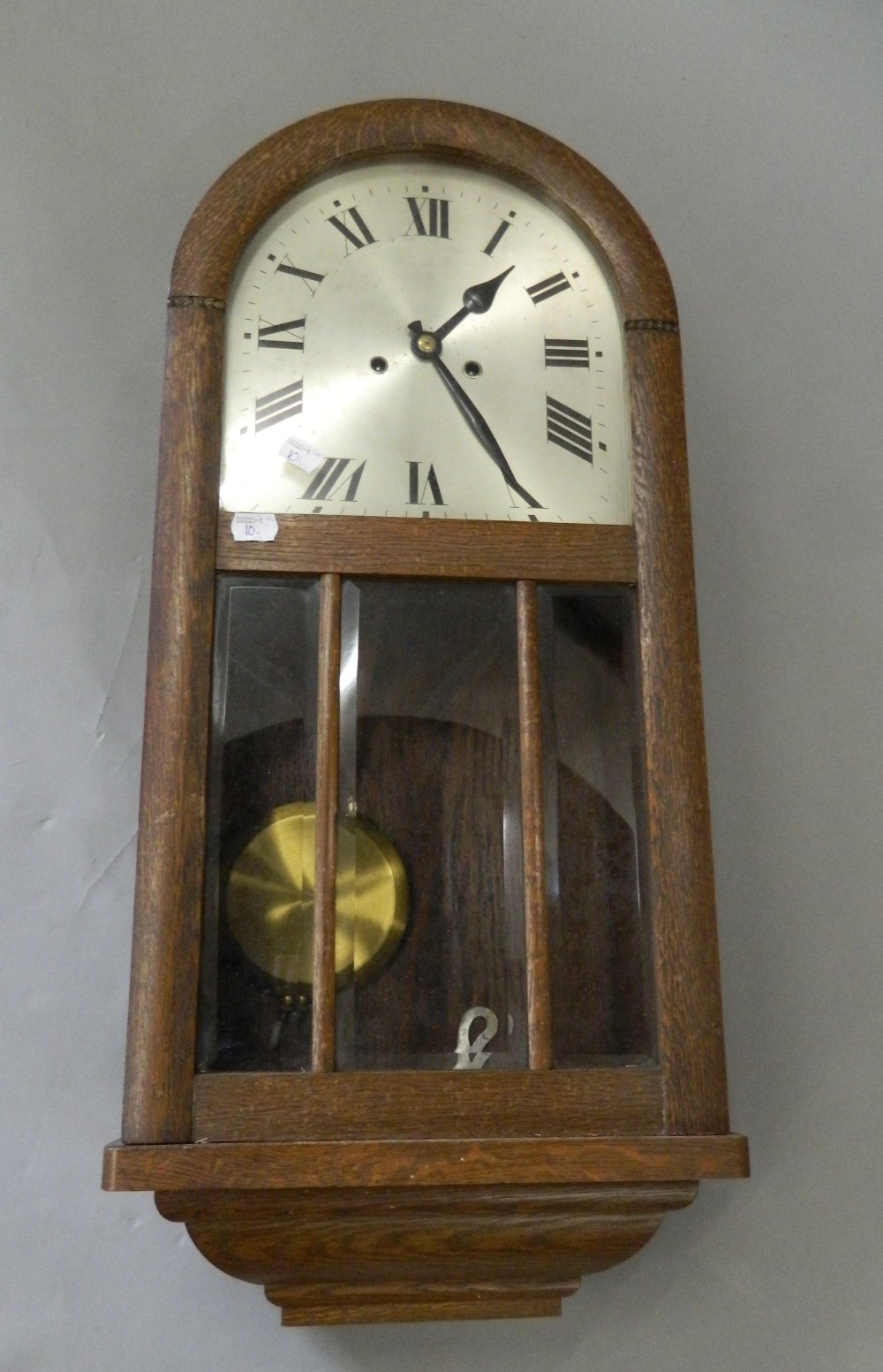 An early 20th century oak wall clock. 72 cm high.