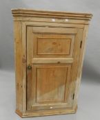 A 19th century pine hanging corner cupboard. 109 cm high.