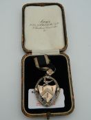 A cased silver medal. The medal 4 cm high.