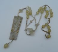 A Chinese pierced jade pendant necklace. The pendant 8 cm high.